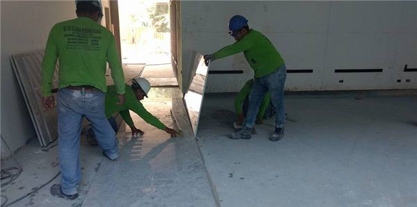 3 men laying white marble